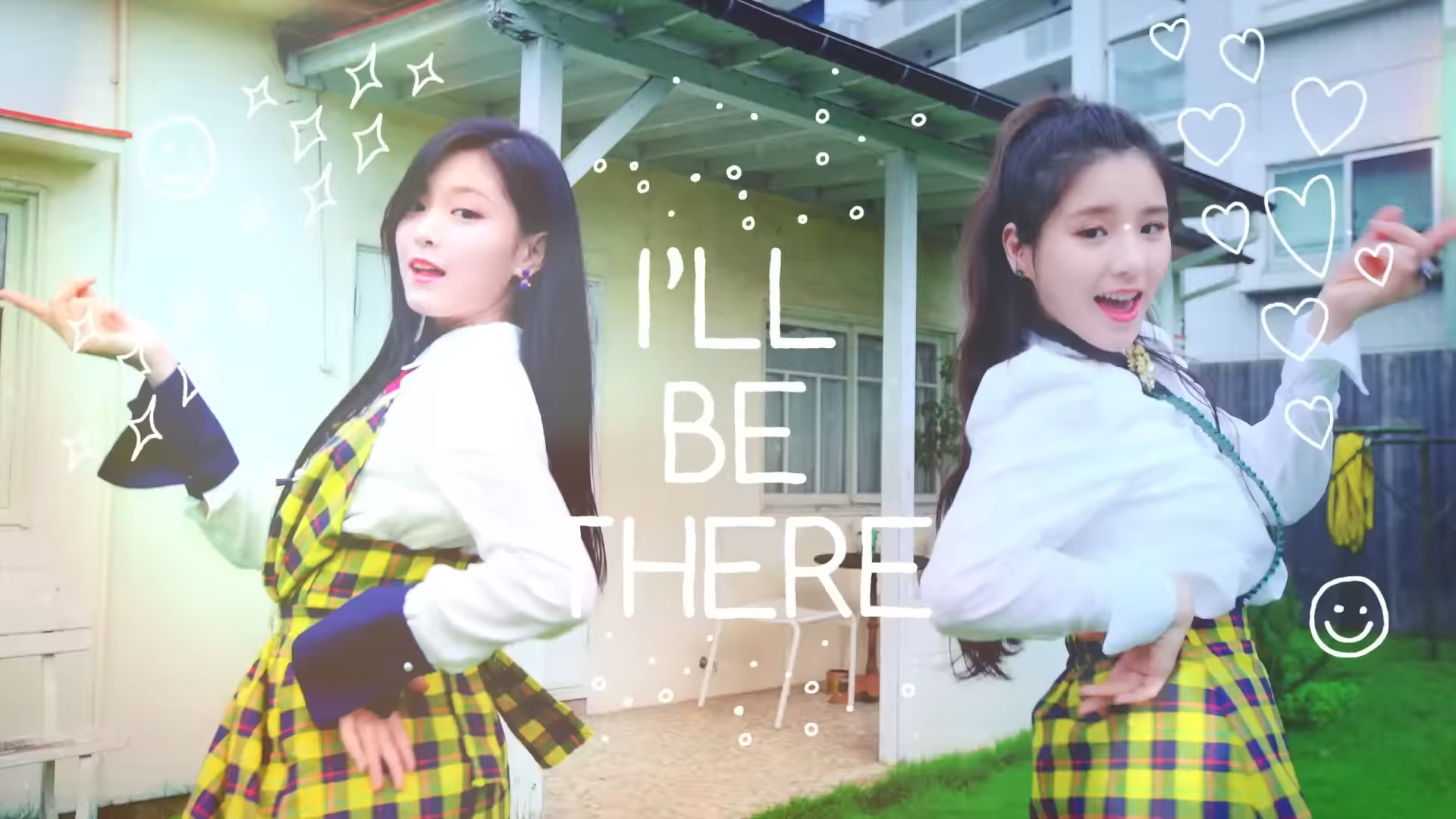 Hyunjin and Heejin dancing in front of a house, from the 'I'll Be There' music video.